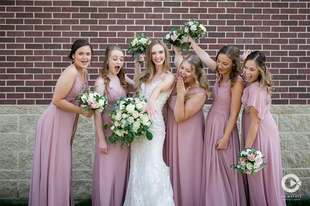 bridesmaids in pink dress with bride