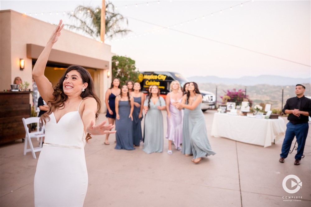 bridesmaids try to catch bouquet