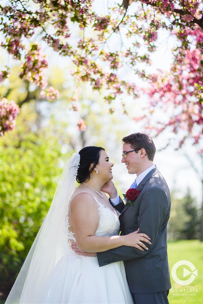 bride and groom under cherry blossom tree