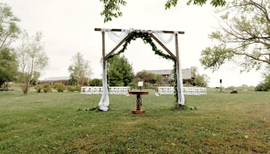 a wedding arch at the outdoor wedding ceremony at Roca Ridge Events