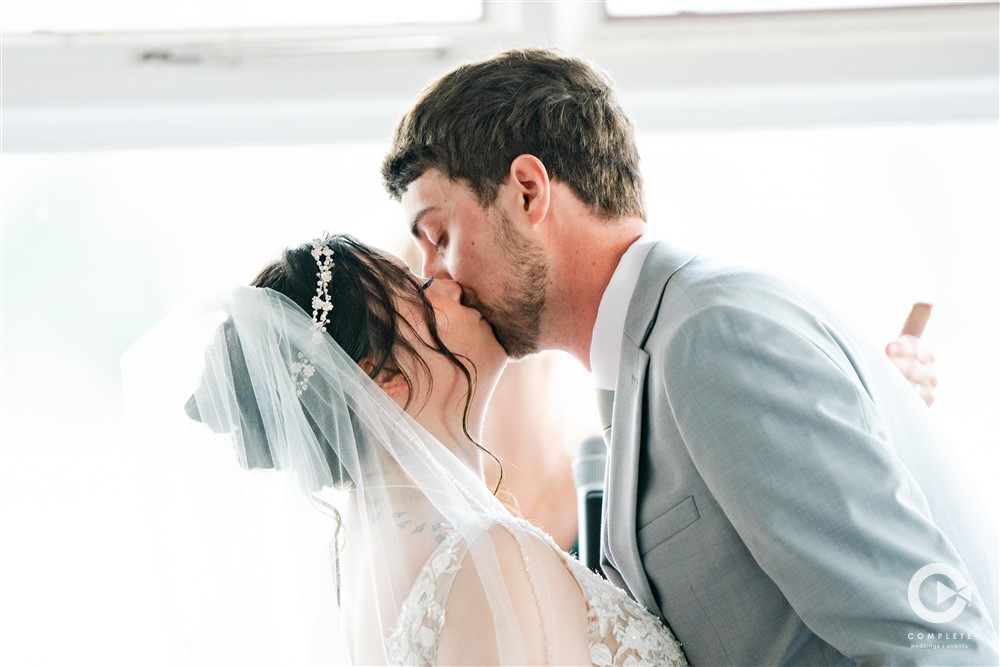 bride and grooms first kiss