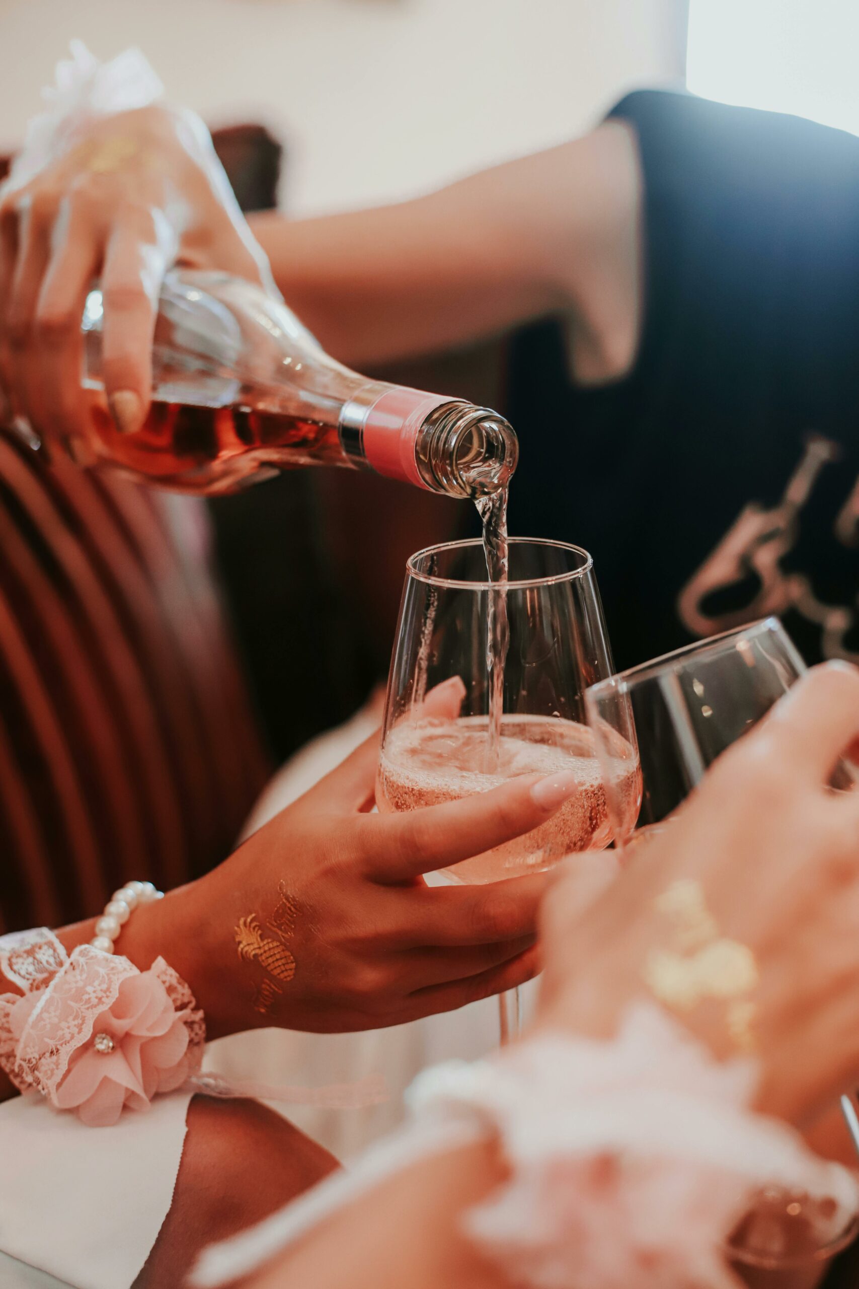 Close-up of Champagne being poured into people's glasses of for Bridesmaids and Groomsmen