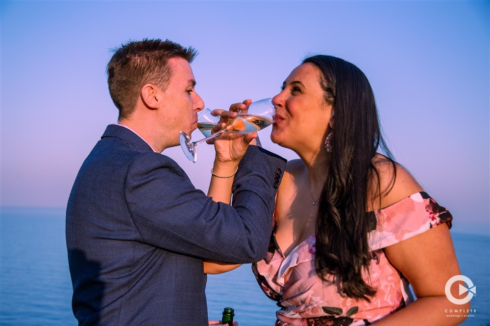 Couple celebrating engagement and drinking champagne
