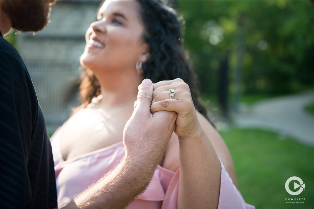 Future Milwaukee bride showing off her new engagement ring in outdoor photo shoot