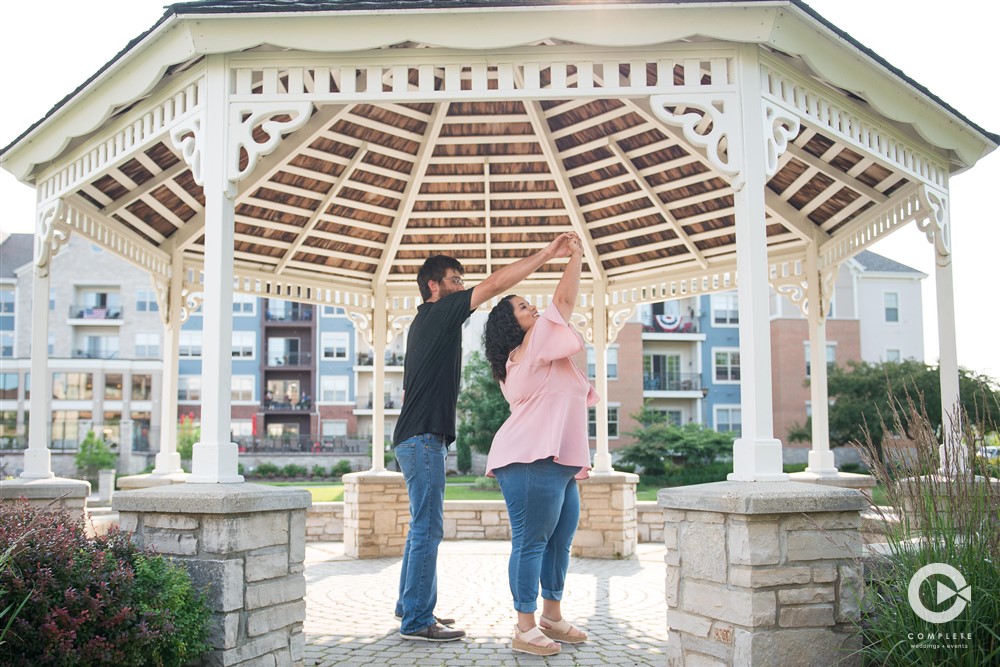 Couple being playful and dancing together in outdoor engagement shoot