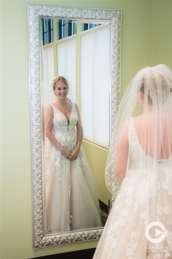 Bride in mirror after getting ready at 13 East Event Center