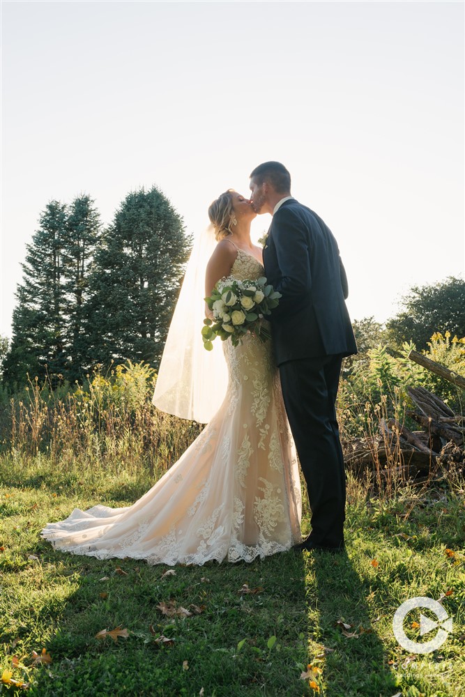 Replanning Your Wedding Bride and groom kiss outside of wedding venue on beautiful wedding day