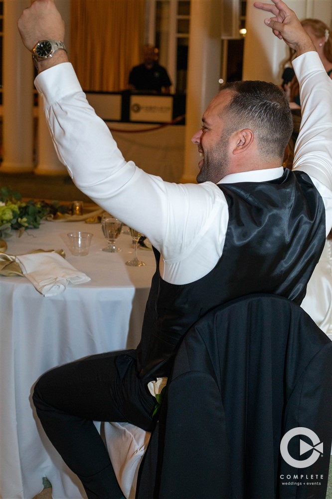 groom celebrating at reception