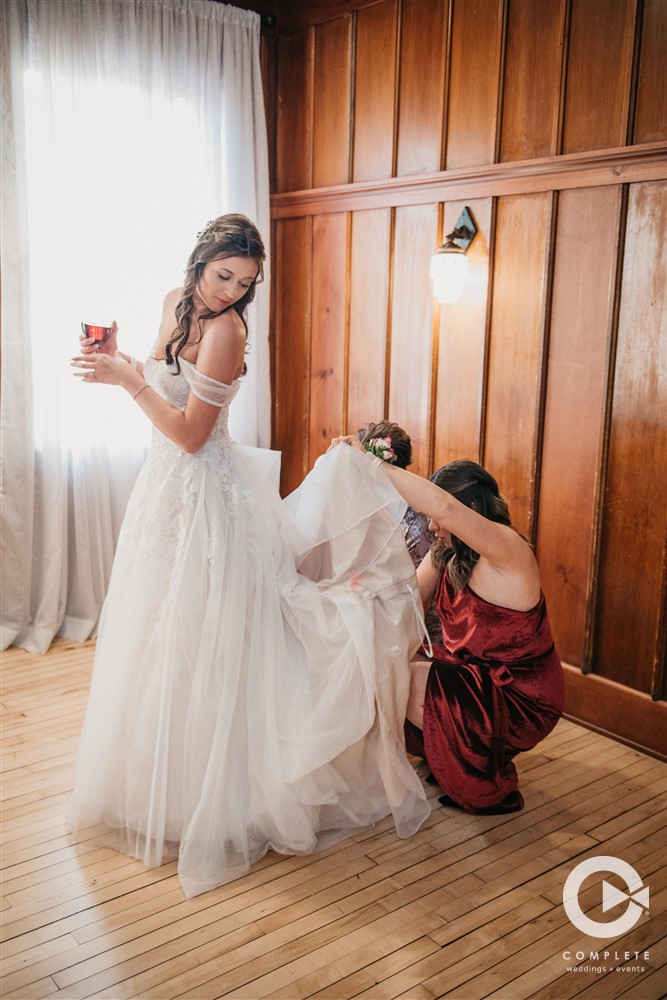 bridesmaids helping bride get ready