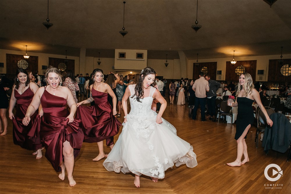 bridesmaids and bride dancing