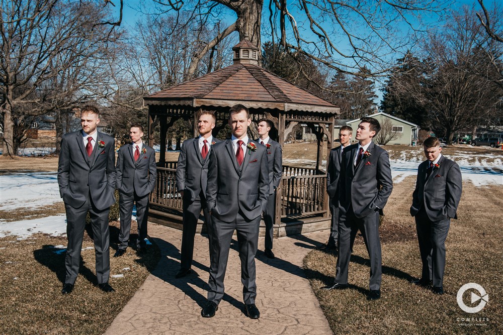 groomsmen in grey suit and red tie