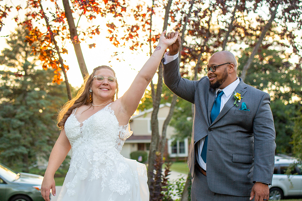 wedding celebration with arms up