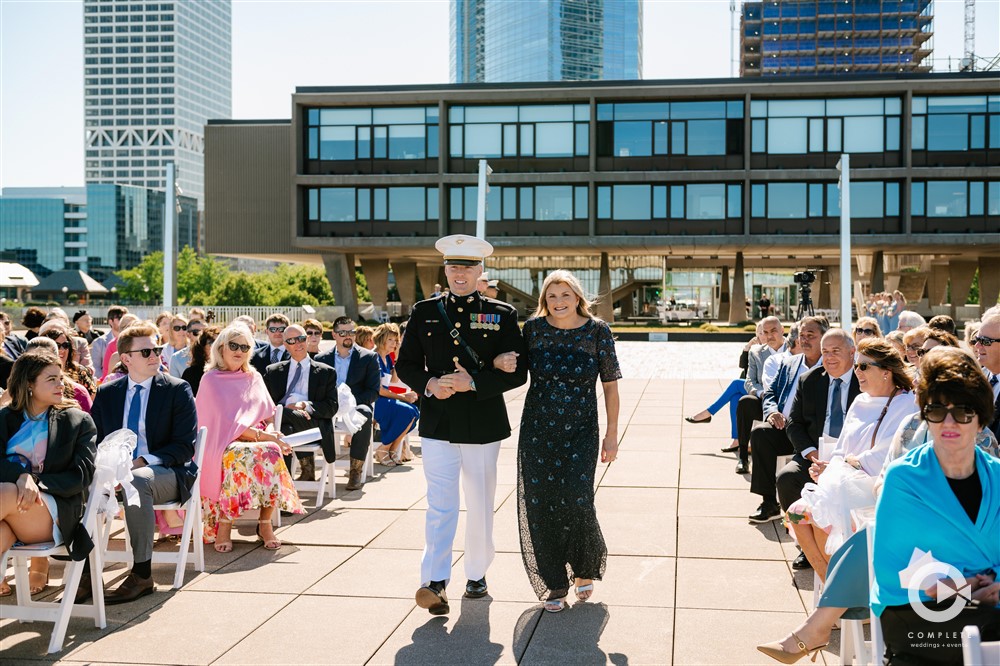 groom and mom walking down the aisle