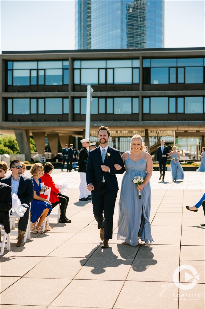 bridesmaid and groomsmen walking down the aisle