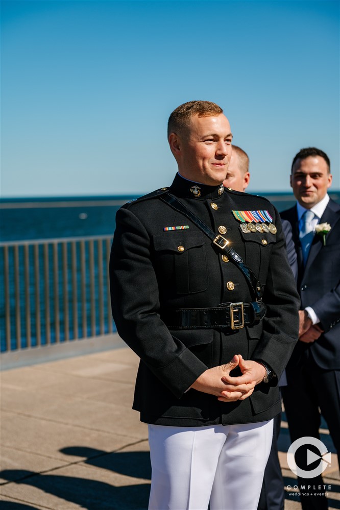 groom watching the bride walk down the aisle