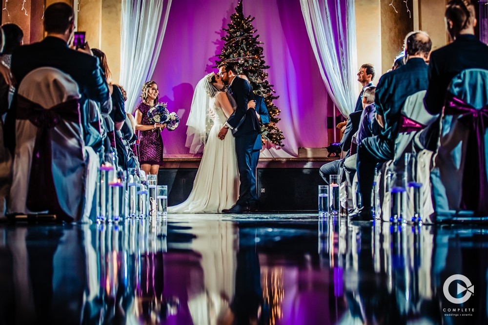 Bride and grooms first kiss in a Minnesota wedding venue.