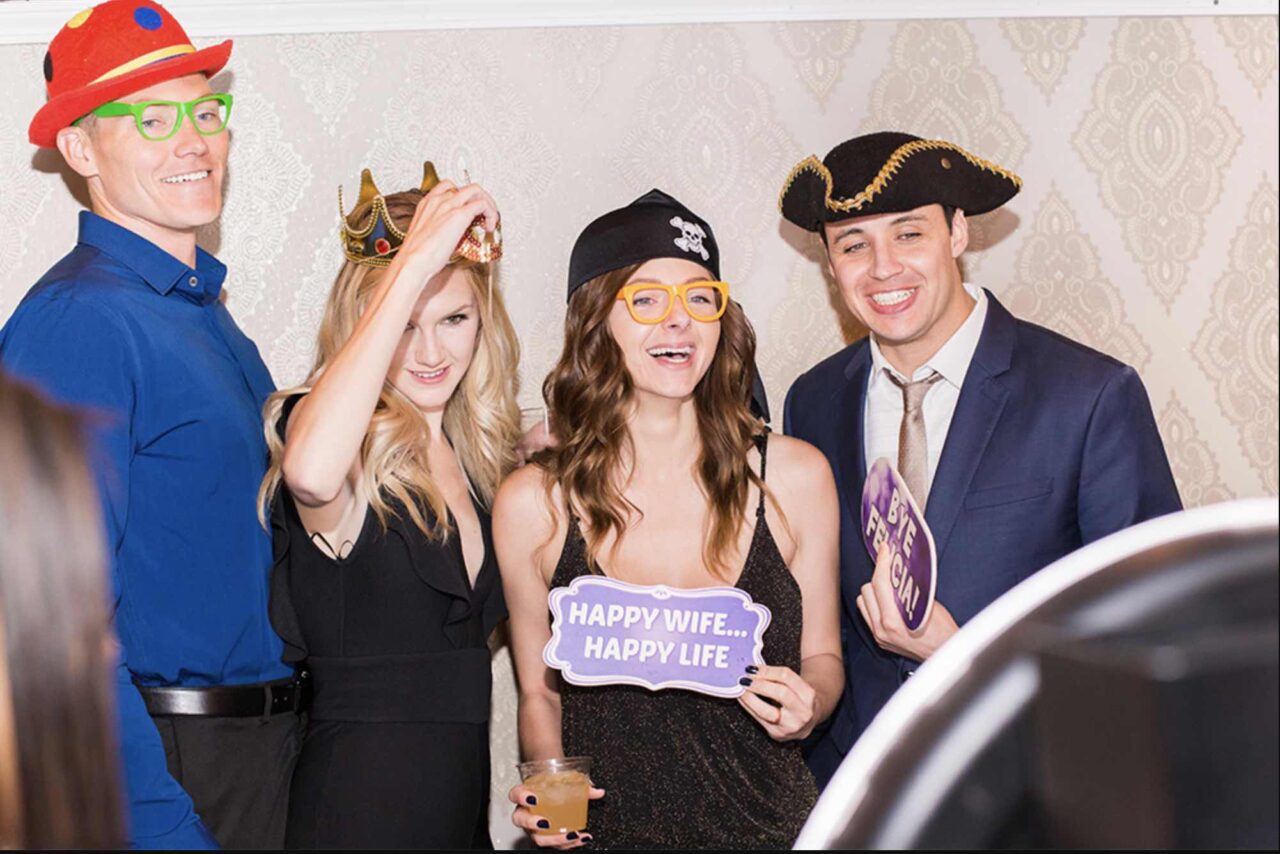 a group taking a photo in a photo booth rental