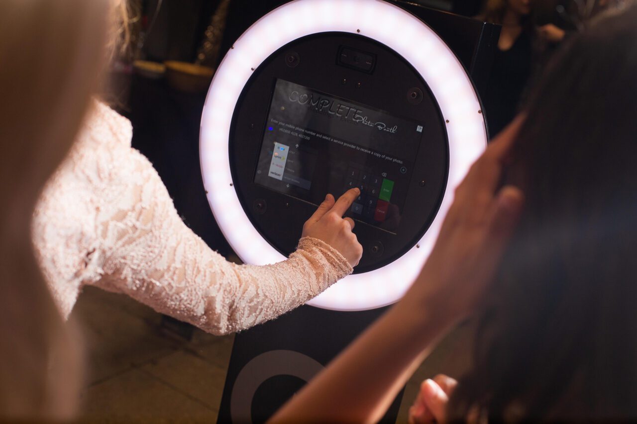 Bride starts the photo booth by selecting buttons on an iPad screen.