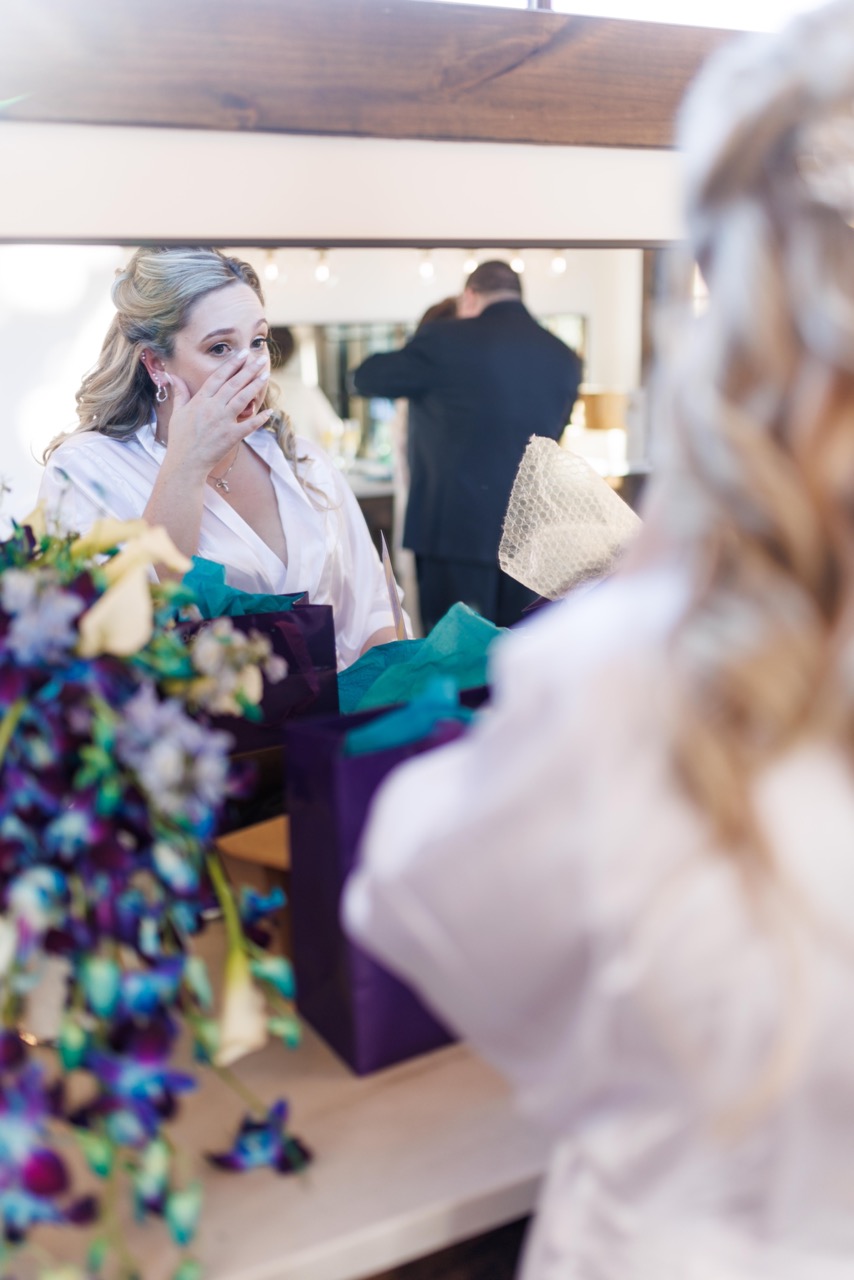 bride gettin emotional about gift from groom