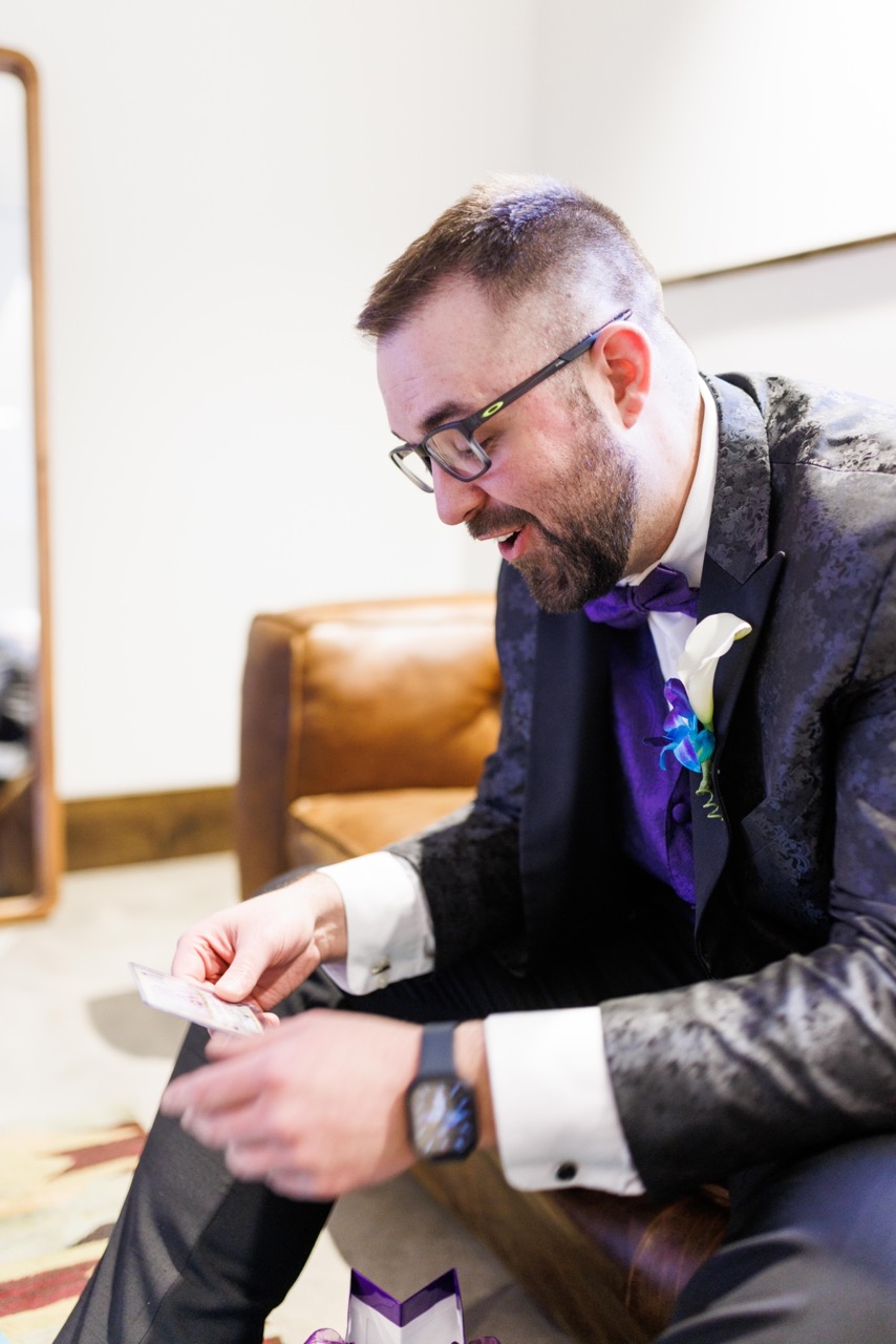 groom opening gift from bride