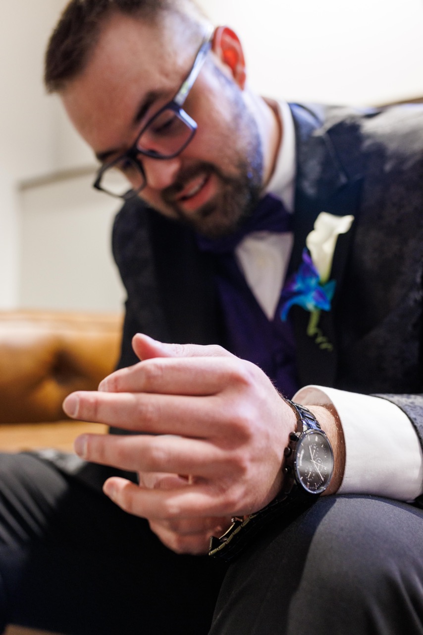 groom putting on watch
