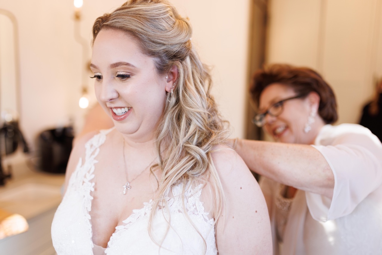 bride putting on her dress