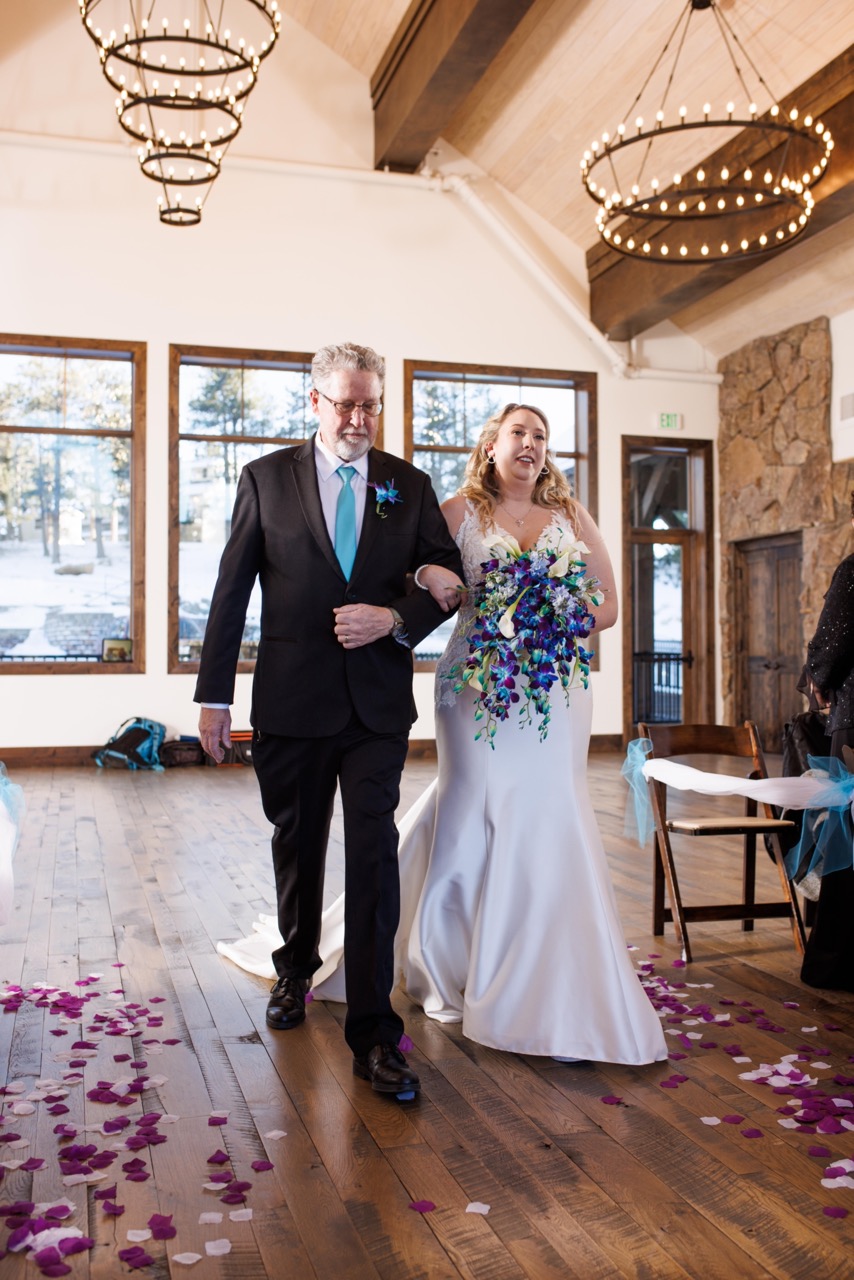 bride walking down the aisle with her father