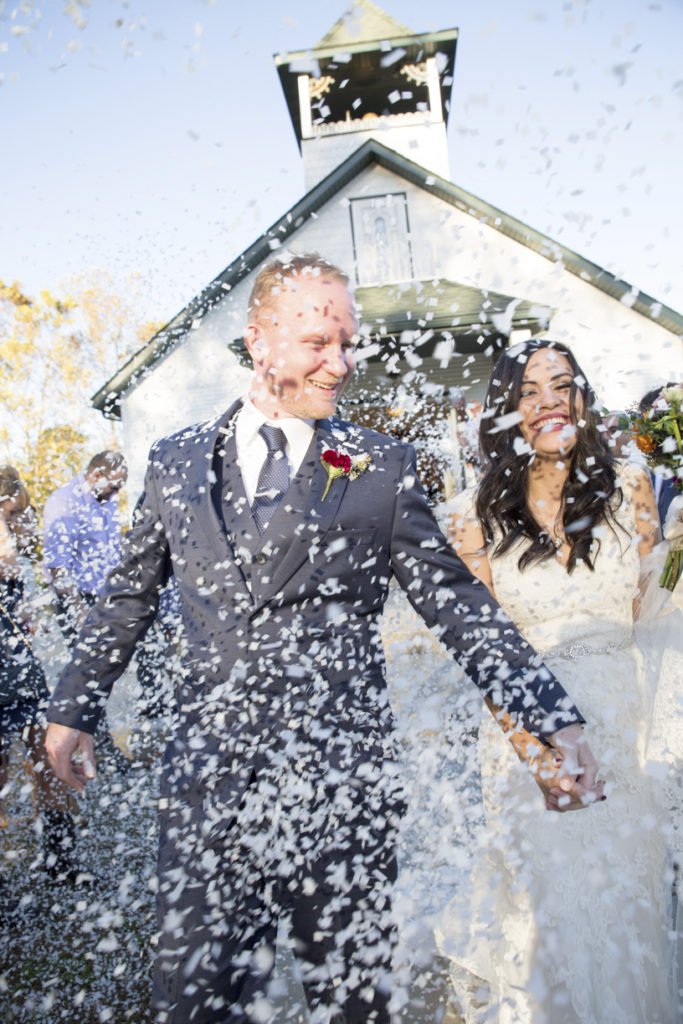 bride and groom recessional | guests throwing confetti