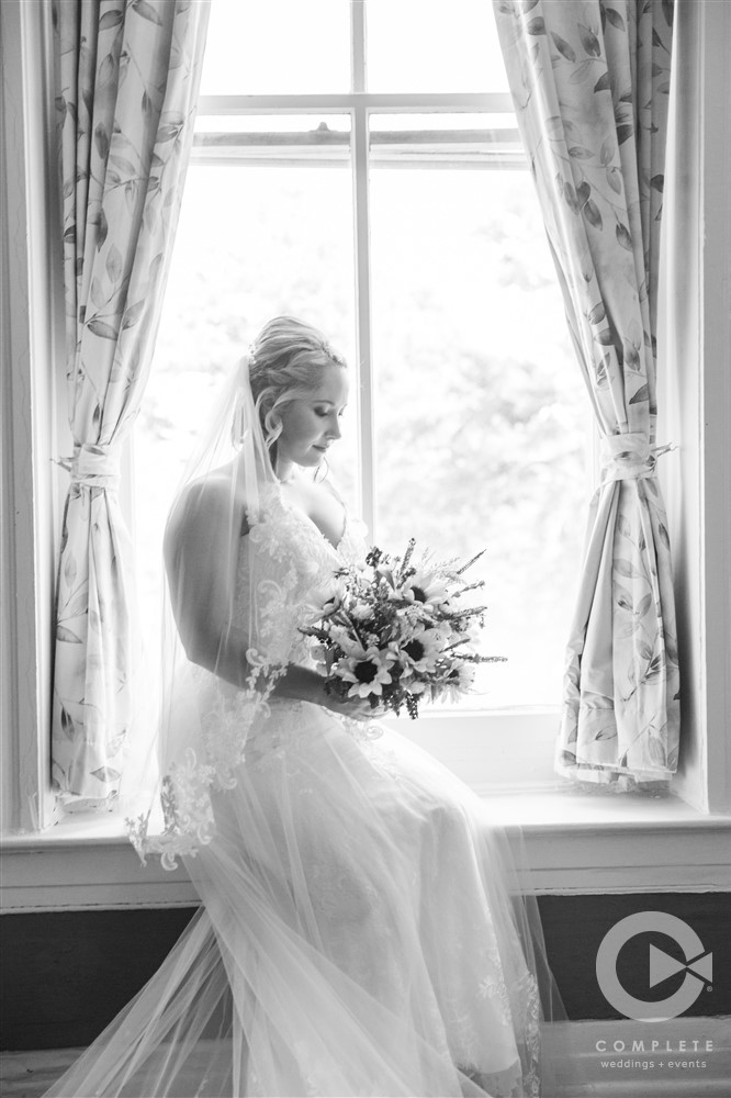 Bride portrait in front of window black and white