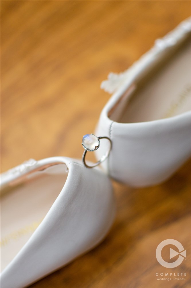 focus shot of wedding ring and bride's shoes