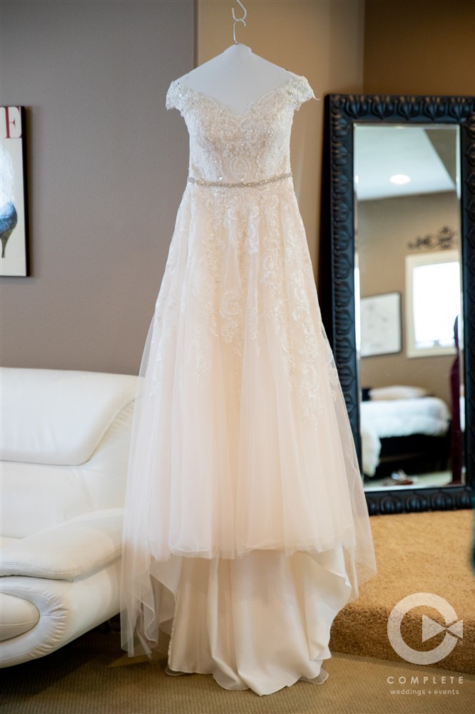 wedding dress hung up in bridal suite