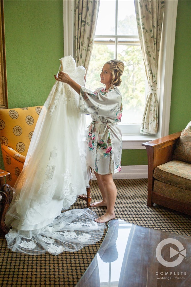 bride inspects wedding dress before ceremony