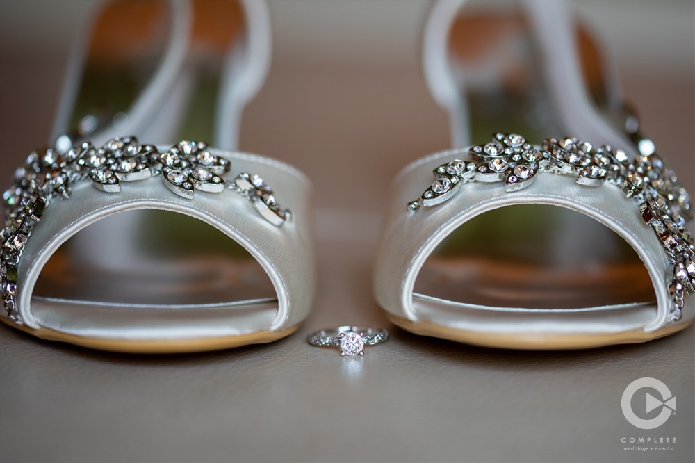 bride's shoes and ring close up sdof shot