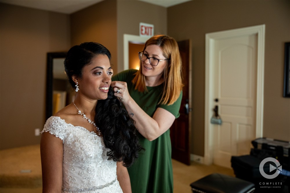 bride's hair being prepared before ceremony