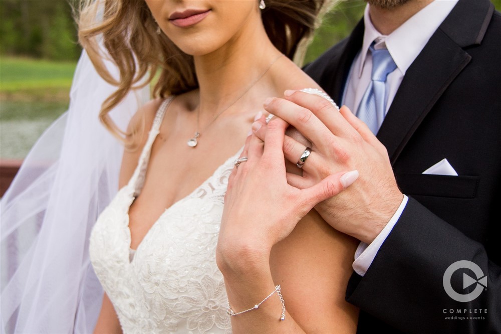 bride and groom hold hands