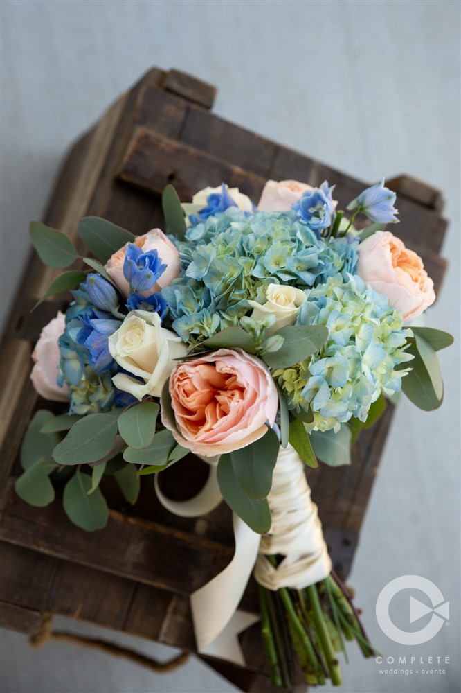 focus shot of blue and pink bridal bouquet