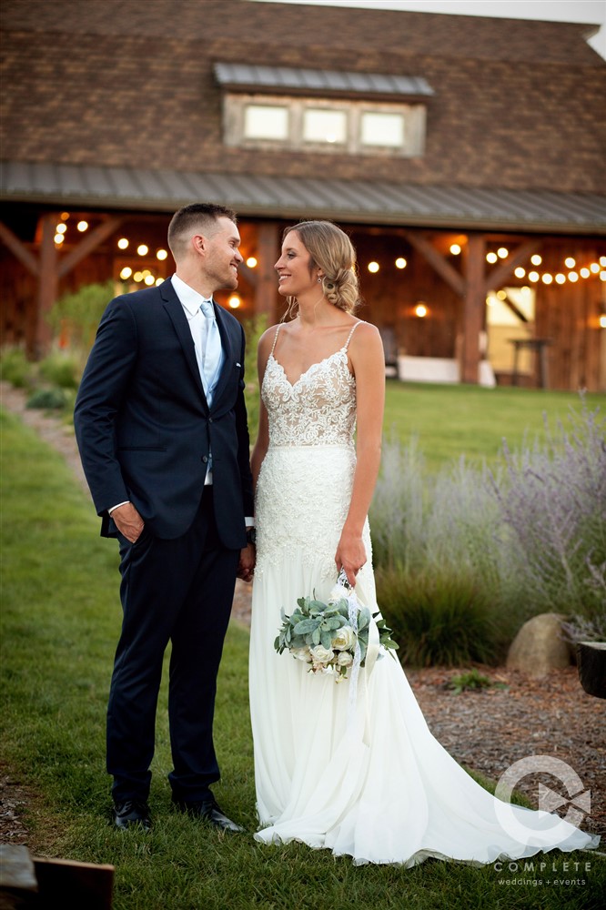 bride and groom in front of sycamore creek family ranch