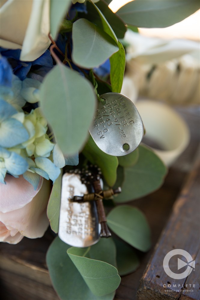 dogtags and cross attached to bouquet