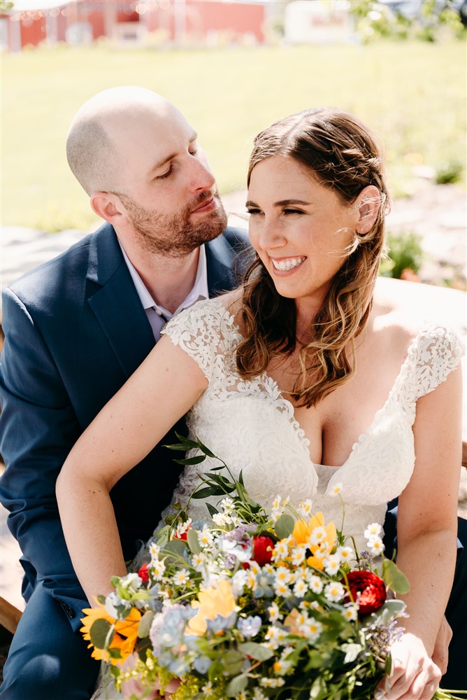 A wedding at Spark Barn a venue located right outside of Omaha, NE doing a cute pose with wedding photographer Erin Mitchell