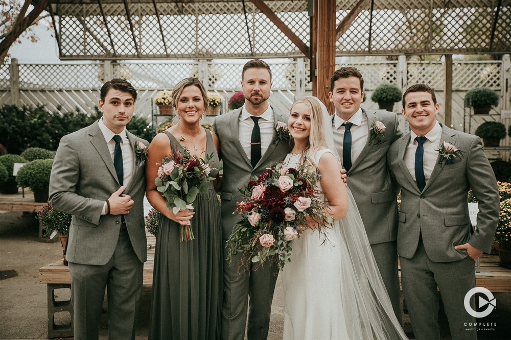 groomsmen and female groom in grey