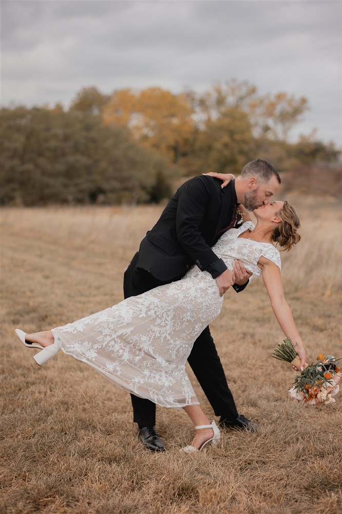 Bride and groom doing a dip at Beardmore Event Center in Omaha, NE with photographer Ade Idowu