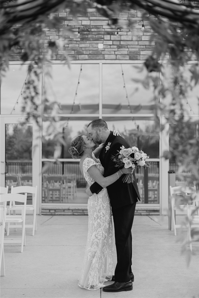 Bride and groom kissing at Beardmore Event Center in Omaha, NE with photographer Ade Idowu