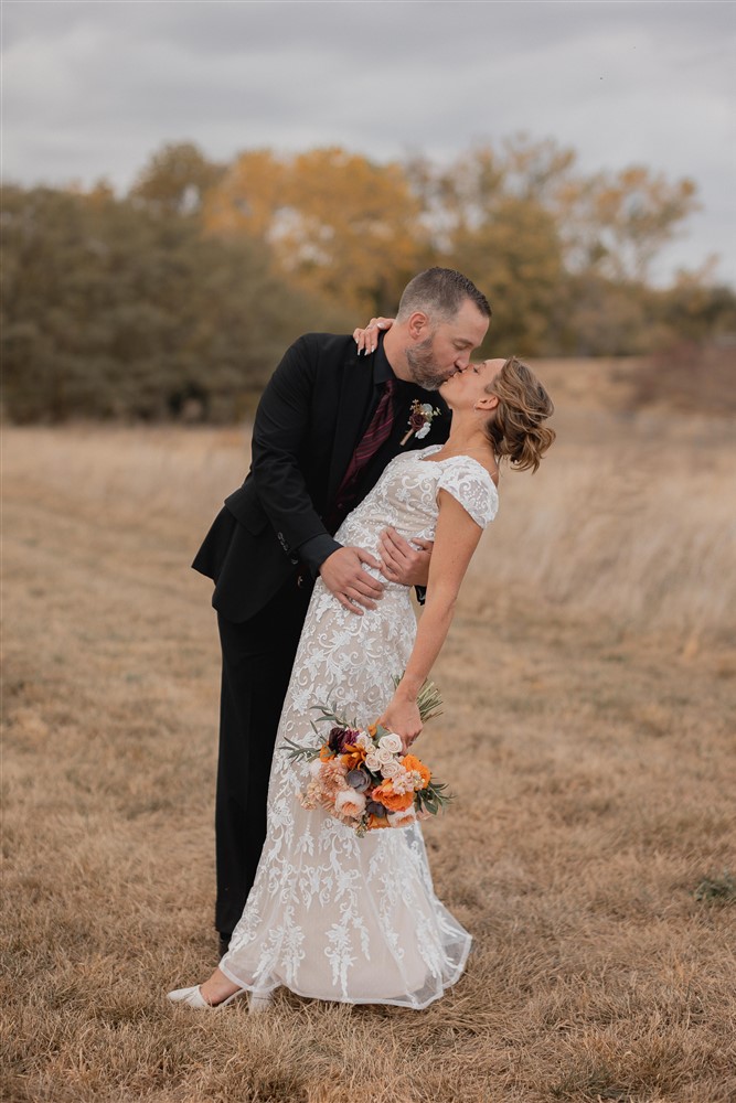 Bride and groom kissing at Beardmore Event Center in Omaha, NE with photographer Ade Idowu