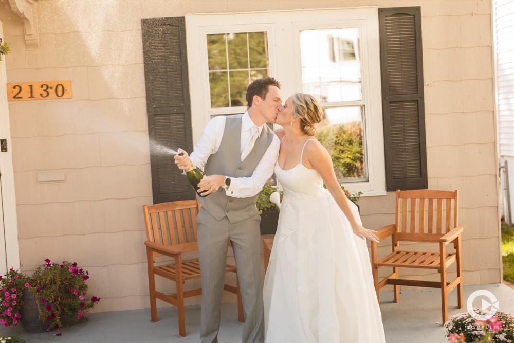 newlyweds popping Champagne