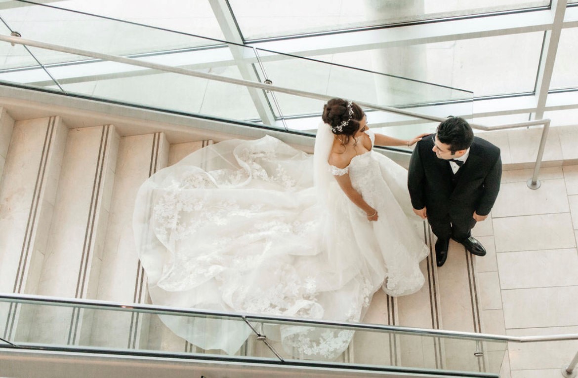 Wedding couple at the end of the stairs Omaha Wedding venue The Farnam shot by Complete Weddings + Events Omaha