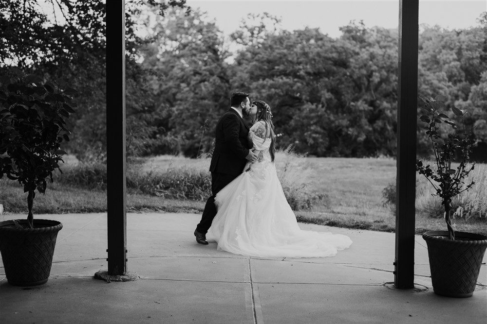 Sharing a kiss at a View in Fontenelle Venue in Omaha NE with wedding photographer Ade Idowu