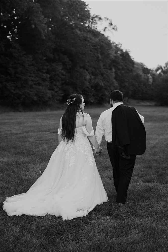 Bride and groom walking at a View in Fontenelle Venue in Omaha NE with wedding photographer Ade Idowu