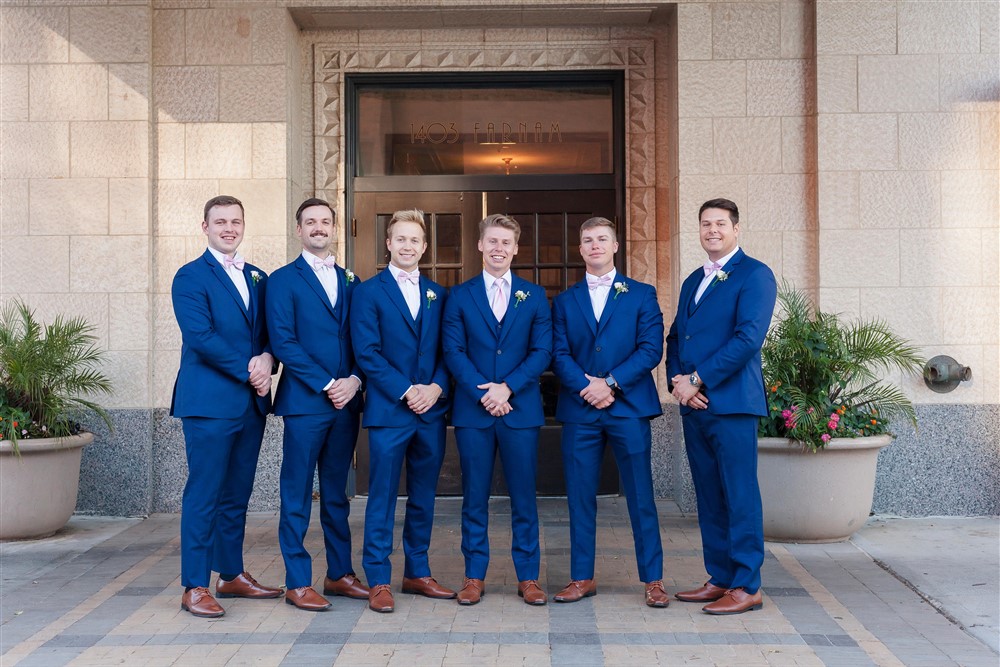 Groom and bridal party at The Paxton venue in Omaha by wedding photographer Shelly Sukstorf