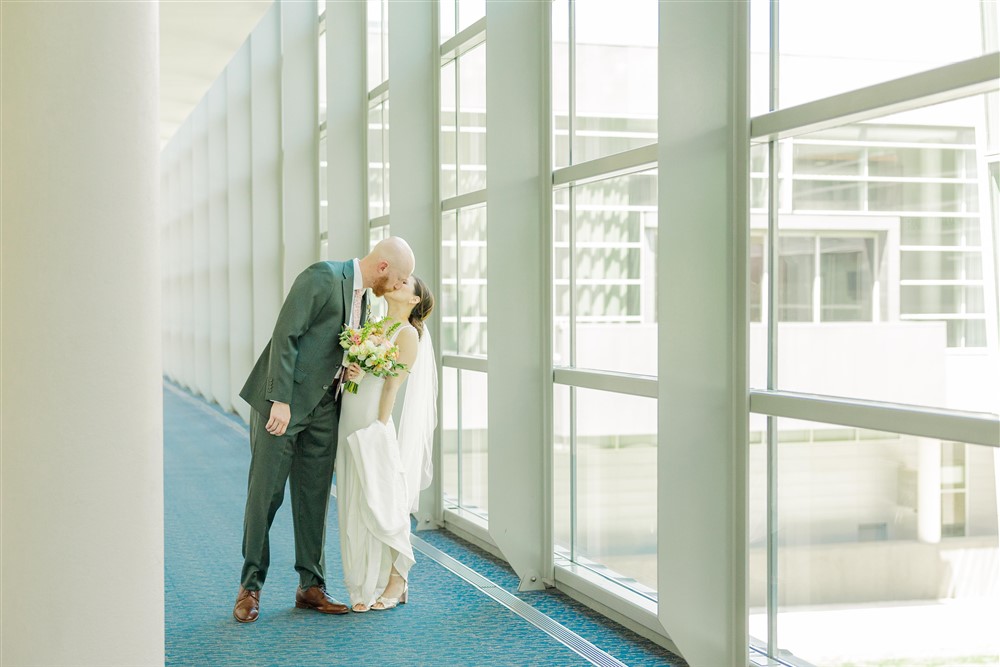 Bride and groom kissing at the Holland Center in Omaha NE with photographer Claire Katan