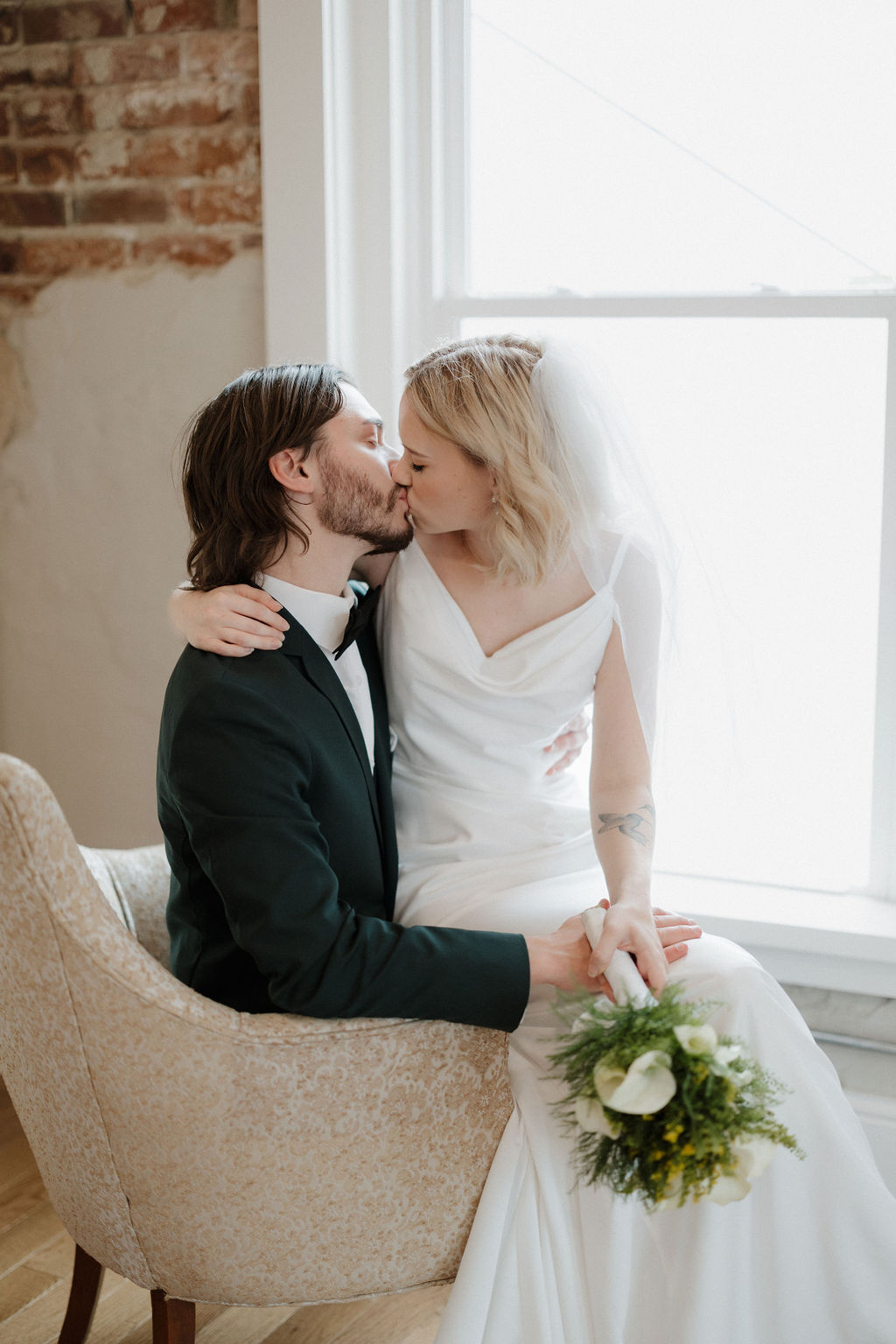 Bride and groom kissing before their beautiful wedding Vanessa with Complete Weddings + Events Omaha wedding photographer